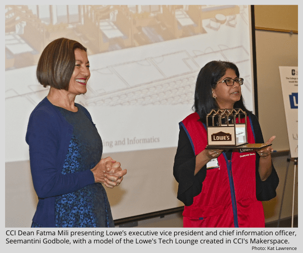 CCI Dean Fatma Mili presenting Lowe's executive vice president and chief information officer, Seemantini Godbole, with a model of the Lowe's Tech Lounge created in CCI's Markerspace.
