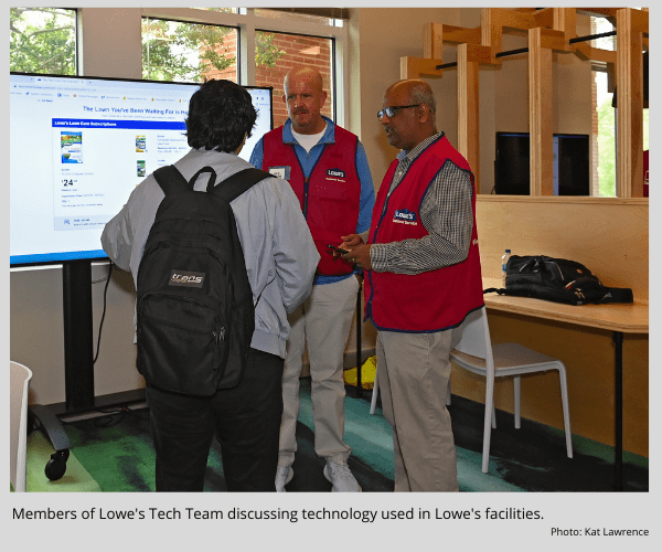 Members of Lowe's Tech Team discussing technology used in Lowe's facilities.