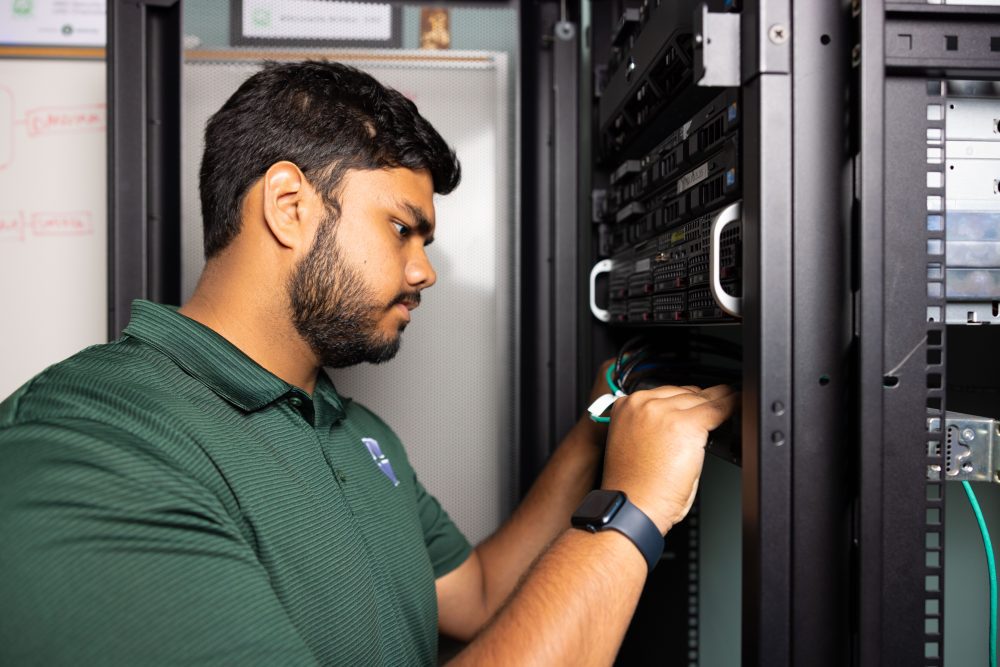 John Gopali working on computer hardware