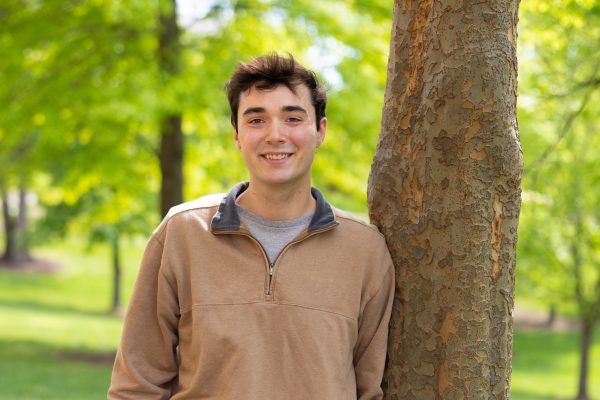 Student Will Russo standing next to a tree on UNC Charlotte campus