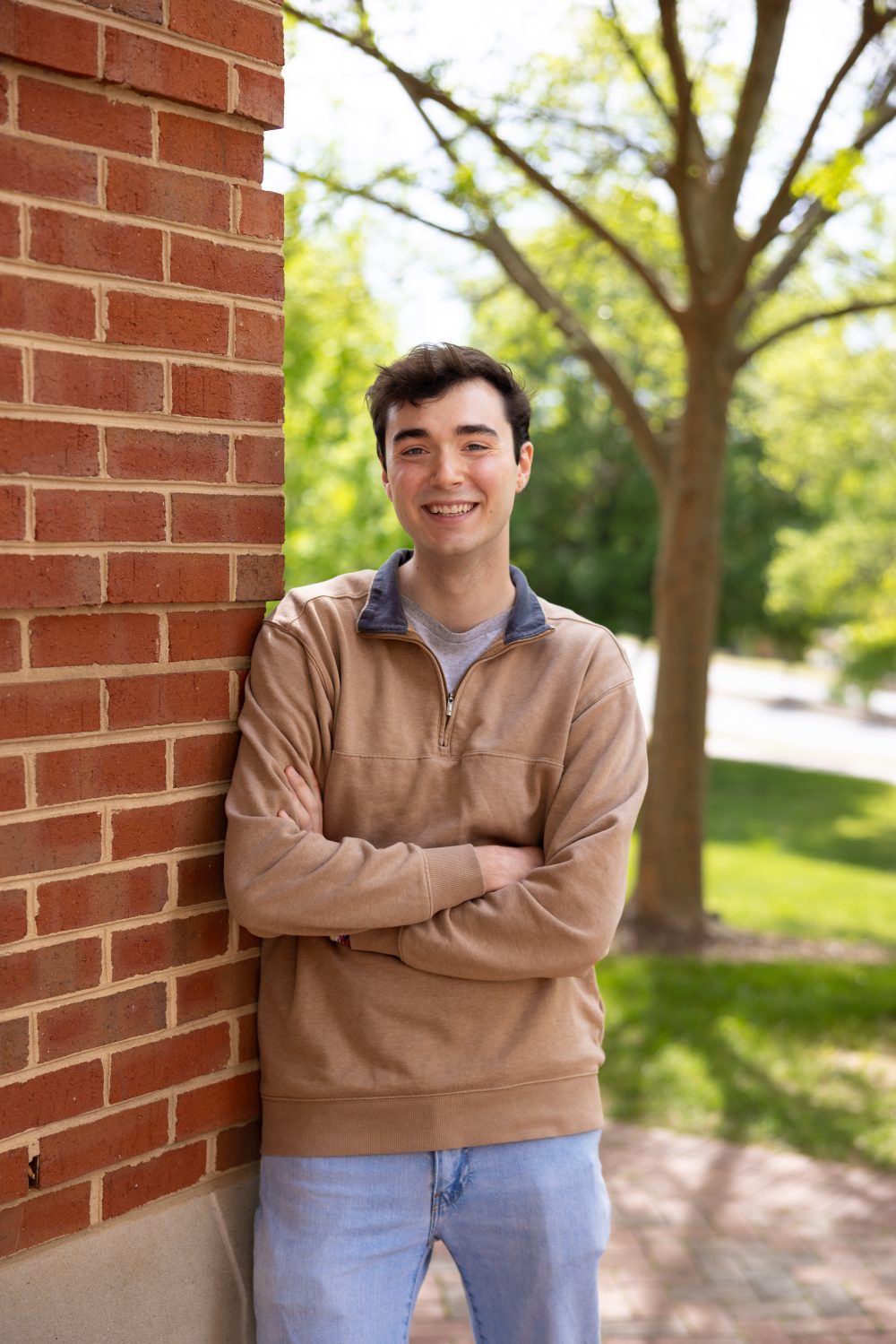 Will Russo standing next to Woodward Hall at UNC Charlotte campus