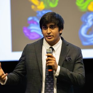 Rishi Misra presents during the final round of 2025's Three-Minute Thesis competition.